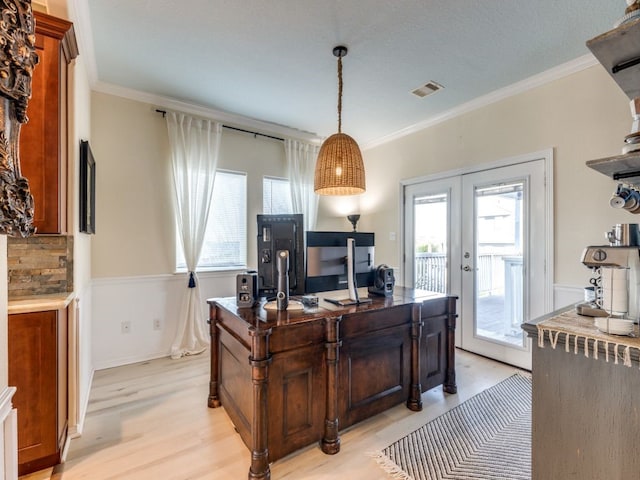 office area with french doors, visible vents, a wealth of natural light, and ornamental molding