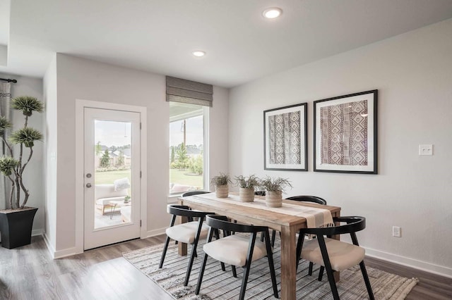 dining room with light wood finished floors, recessed lighting, and baseboards