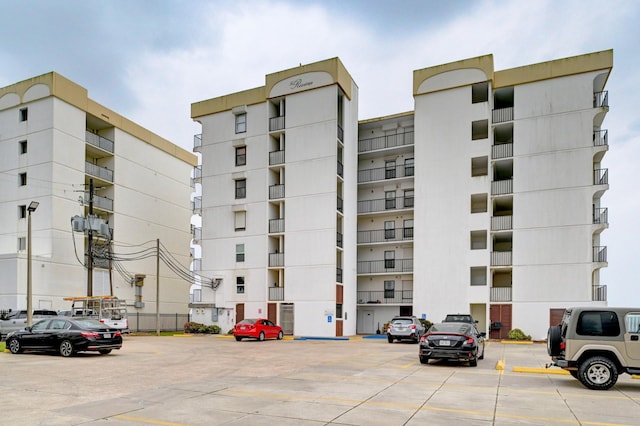 view of building exterior featuring uncovered parking