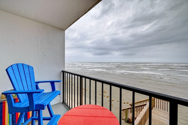 balcony with a beach view and a water view