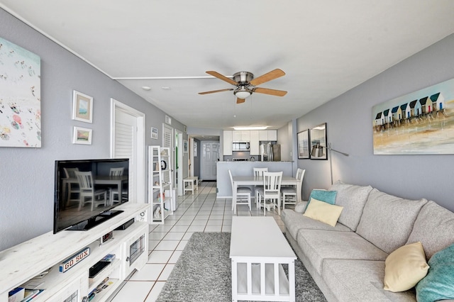 living area featuring light tile patterned flooring and a ceiling fan