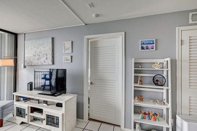 interior space featuring light tile patterned floors and visible vents