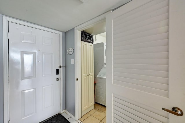 foyer entrance with light tile patterned floors and radiator