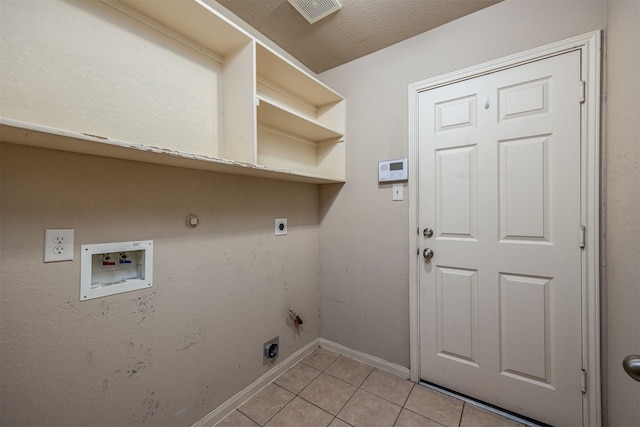 219 Boxwood Dr, Baytown, TX 77520 - clothes washing area with electric dryer hookup, light tile patterned flooring, hookup for a washing machine, gas dryer hookup, and baseboards
