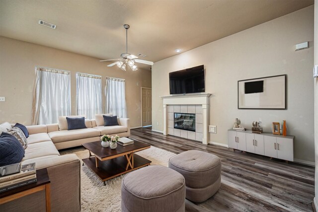 219 Boxwood Dr, Baytown, TX 77520 - living area featuring wood finished floors, ceiling fan, a tiled fireplace, baseboards, and recessed lighting