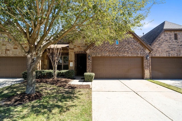 24146 Valencia Ridge Ln, Katy, TX 77494 - view of front of property with a garage, brick siding, roof with shingles, and driveway