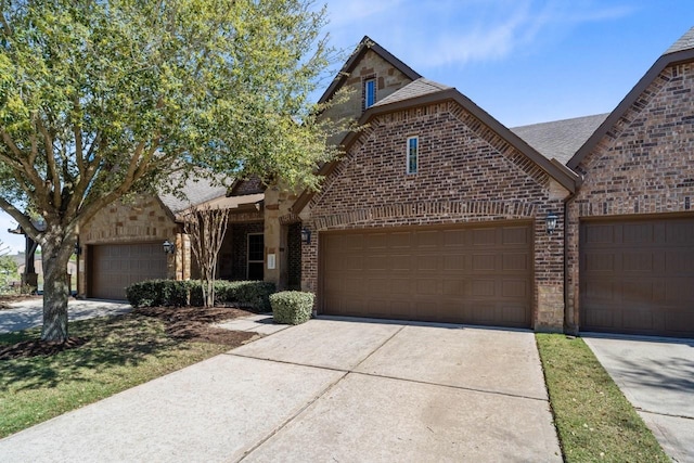 24146 Valencia Ridge Ln, Katy, TX 77494 - view of front facade featuring brick siding, an attached garage, and driveway