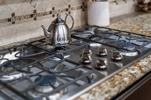 24146 Valencia Ridge Ln, Katy, TX 77494 - interior details with backsplash and gas stovetop