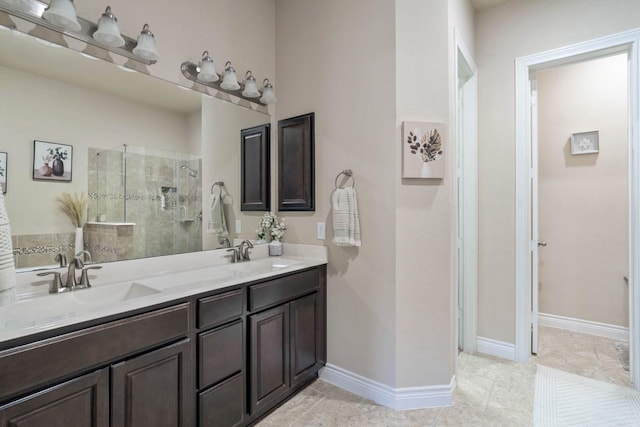 24146 Valencia Ridge Ln, Katy, TX 77494 - full bathroom featuring a tile shower, double vanity, baseboards, and a sink