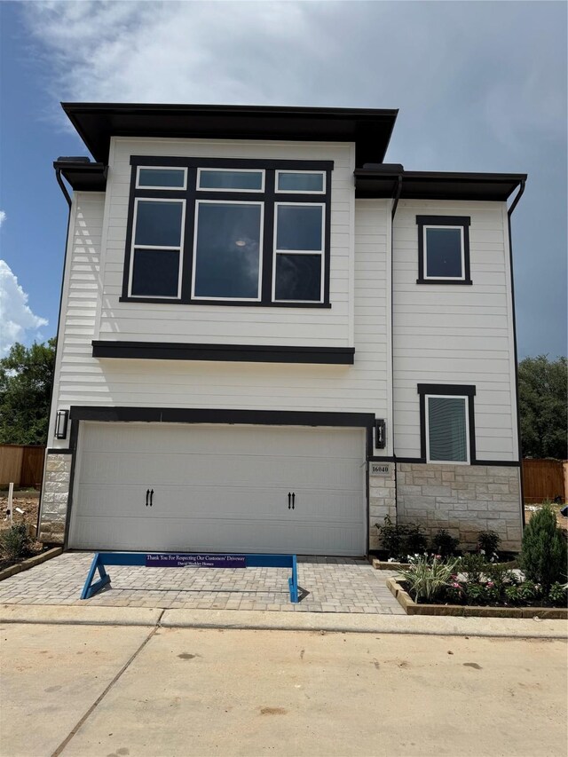16040 Mason Run Dr, Houston, TX 77079 - view of front of home featuring stone siding, an attached garage, and driveway