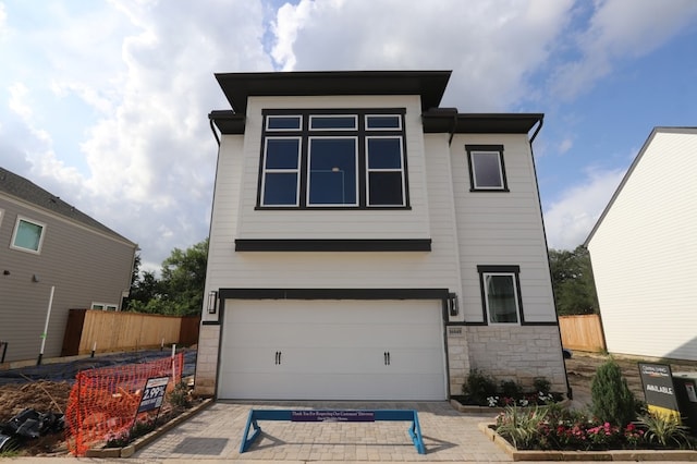 16040 Mason Run Dr, Houston, TX 77079 - view of front of house with an attached garage, stone siding, and driveway
