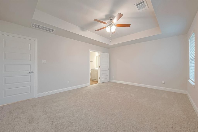 416 Bryan Way, Angleton, TX 77515 - empty room featuring a raised ceiling, ceiling fan, and light carpet