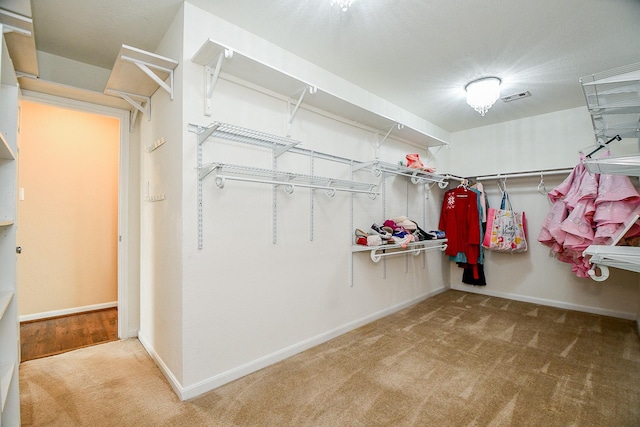 spacious closet with carpet floors and visible vents