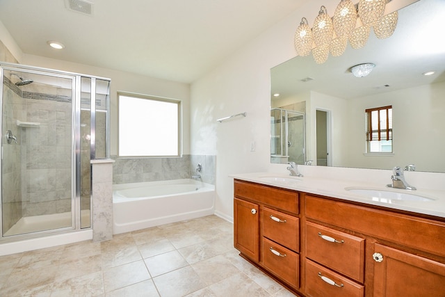 bathroom with plenty of natural light, visible vents, a sink, and a stall shower