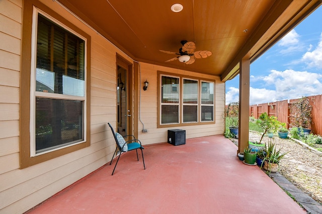 view of patio featuring fence and a ceiling fan
