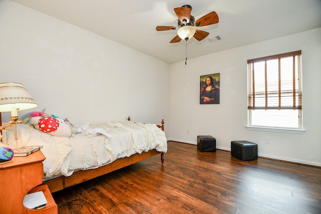bedroom featuring ceiling fan, baseboards, wood finished floors, and visible vents