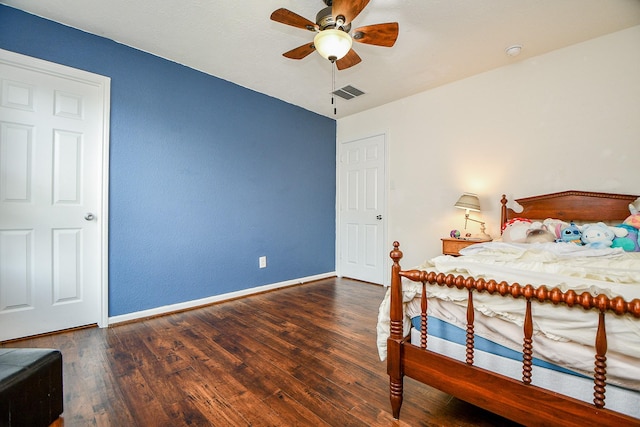 bedroom with baseboards, a ceiling fan, wood finished floors, and visible vents