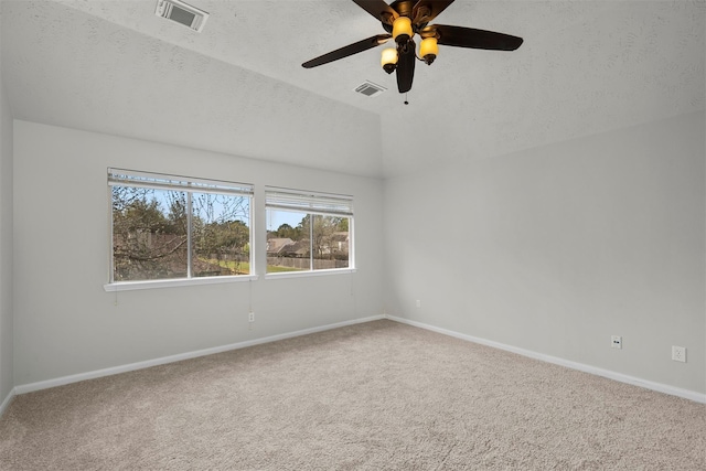 16935 Valley Palms Dr, Spring, TX 77379 - spare room featuring lofted ceiling, carpet flooring, baseboards, ceiling fan, and a textured ceiling