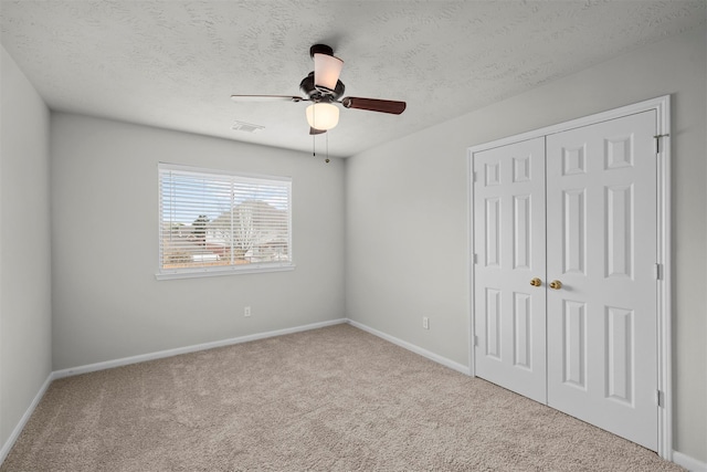 16935 Valley Palms Dr, Spring, TX 77379 - unfurnished bedroom with carpet, a closet, baseboards, and a textured ceiling