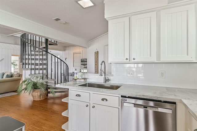 23155 Gulf Dr, Galveston, TX 77554 - kitchen featuring wood finished floors, visible vents, a sink, white cabinets, and stainless steel dishwasher