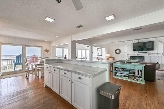 23155 Gulf Dr, Galveston, TX 77554 - kitchen with open floor plan, wood finished floors, visible vents, and ceiling fan