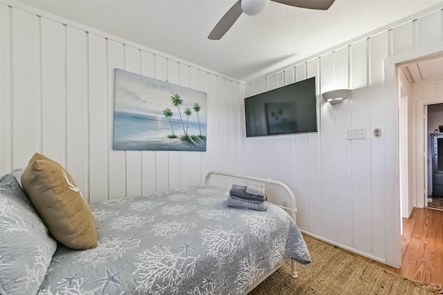 23155 Gulf Dr, Galveston, TX 77554 - bedroom with ceiling fan, a textured ceiling, attic access, and wood finished floors