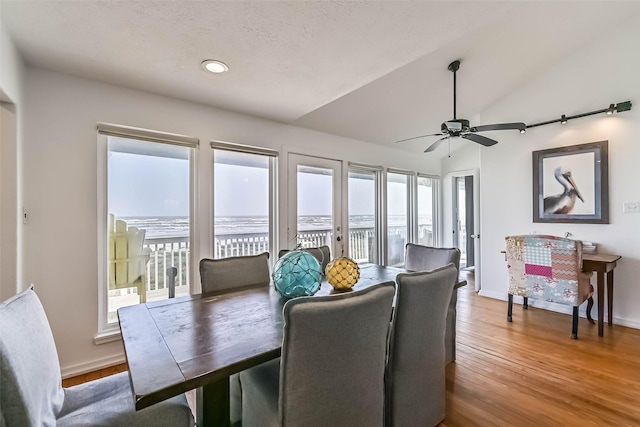 23155 Gulf Dr, Galveston, TX 77554 - dining area featuring lofted ceiling, wood finished floors, baseboards, and ceiling fan