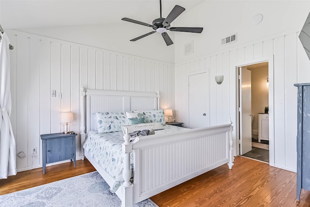 23155 Gulf Dr, Galveston, TX 77554 - bedroom with visible vents, connected bathroom, ceiling fan, vaulted ceiling, and wood finished floors