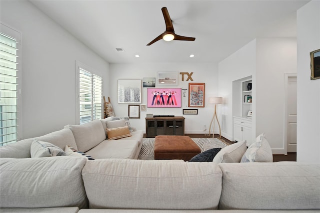 living room featuring visible vents, baseboards, ceiling fan, recessed lighting, and wood finished floors