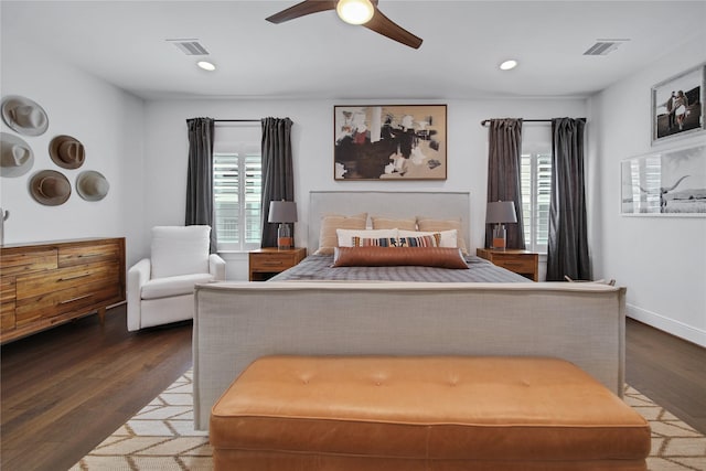 bedroom with wood finished floors, multiple windows, and visible vents