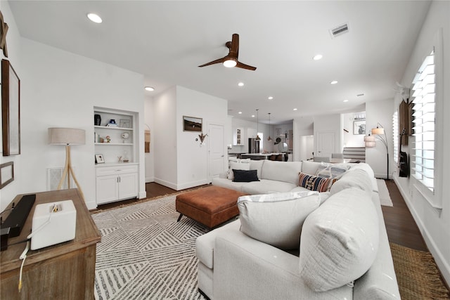 living room with visible vents, ceiling fan, recessed lighting, and dark wood finished floors