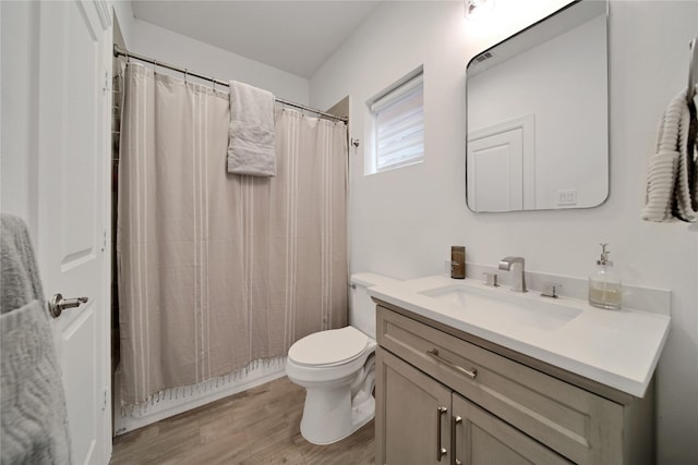 full bathroom featuring toilet, a shower with curtain, vanity, and wood finished floors