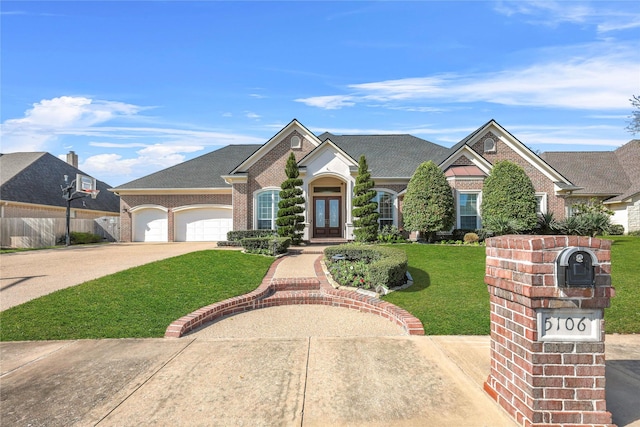 5106 Bellerive Bend Dr, College Station, TX 77845 - view of front of house with french doors, brick siding, driveway, and a garage
