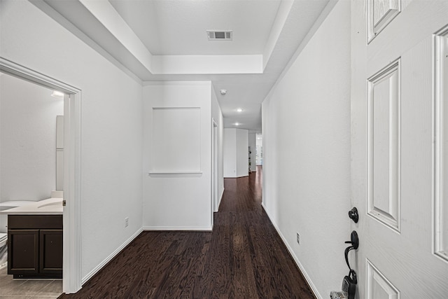 corridor with recessed lighting, visible vents, baseboards, and wood finished floors