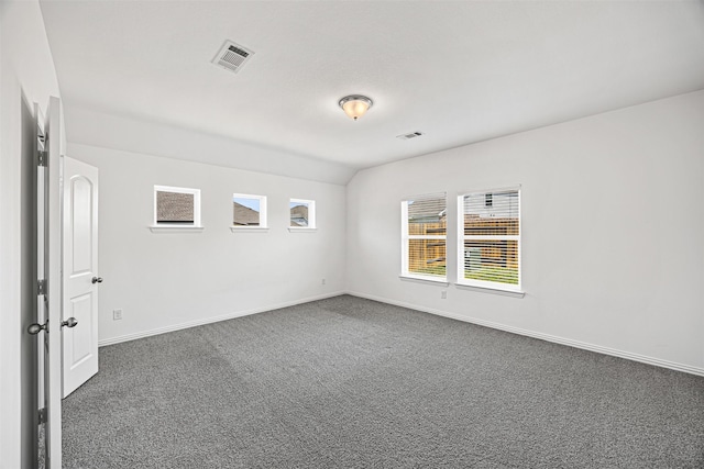 empty room with baseboards, carpet, visible vents, and a wealth of natural light