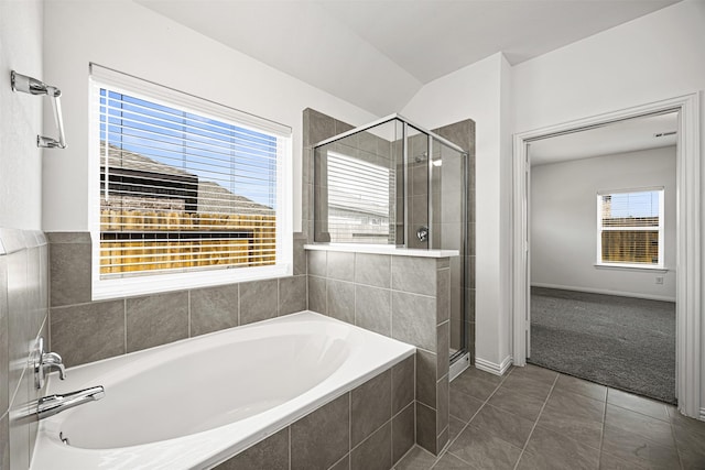 full bath with a bath, baseboards, tile patterned floors, a stall shower, and lofted ceiling