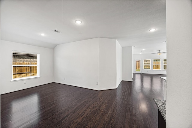 unfurnished living room with baseboards, recessed lighting, a ceiling fan, dark wood-type flooring, and visible vents