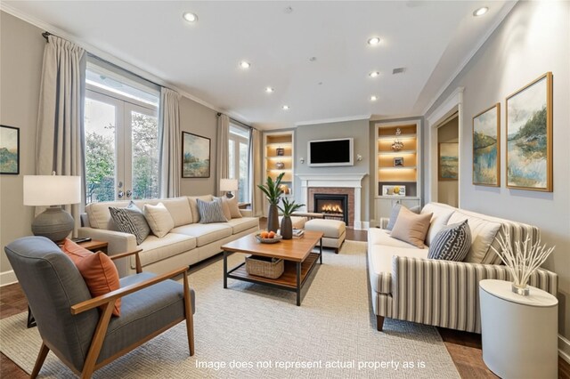3126 Mid Ln, Houston, TX 77027 - living room featuring built in features, recessed lighting, crown molding, a warm lit fireplace, and wood finished floors