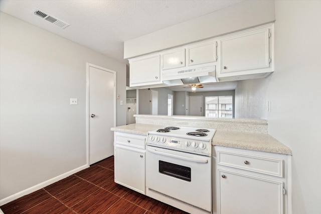 4029 Briar Hollow Dr, Dickinson, TX 77539 - kitchen with white cabinets, visible vents, light countertops, under cabinet range hood, and white range with electric cooktop