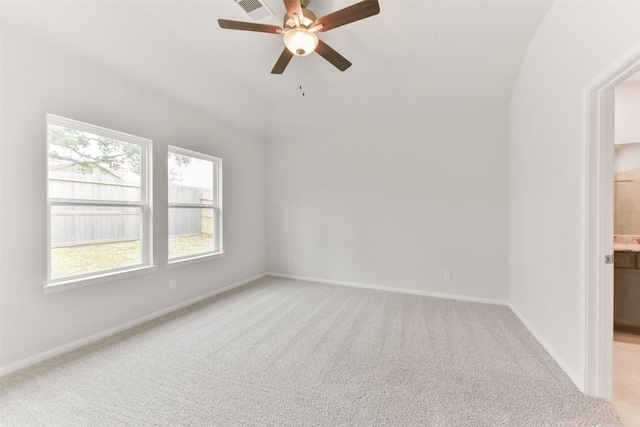 empty room with visible vents, a ceiling fan, baseboards, and light carpet