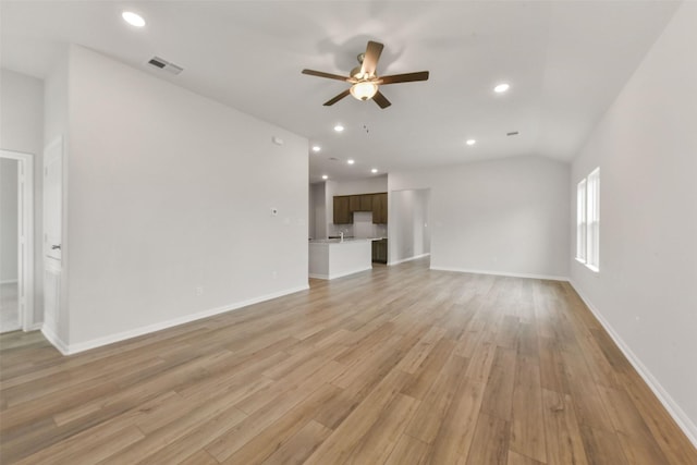 unfurnished living room featuring light wood-type flooring, visible vents, a ceiling fan, recessed lighting, and baseboards