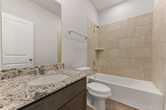 full bath featuring vanity, toilet, wood finished floors, and shower / bathtub combination