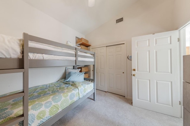 carpeted bedroom with ceiling fan, visible vents, lofted ceiling, and a closet