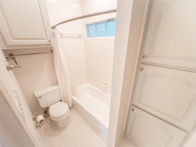 bathroom featuring toilet and shower / bath combination with curtain