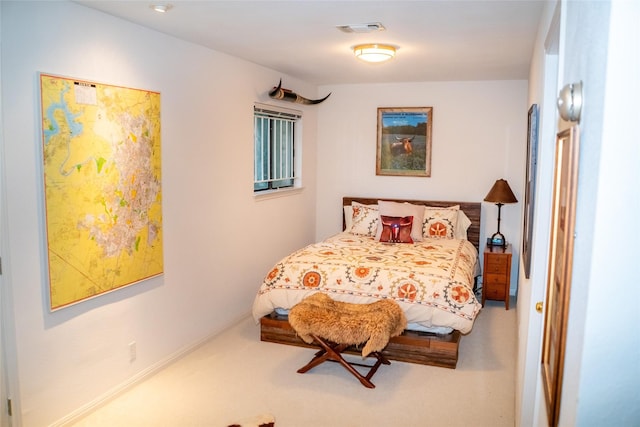 carpeted bedroom featuring visible vents