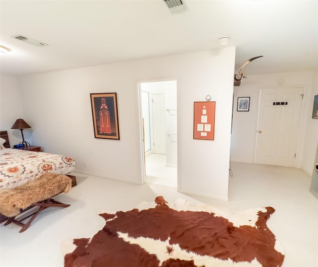 bedroom with carpet, connected bathroom, and visible vents