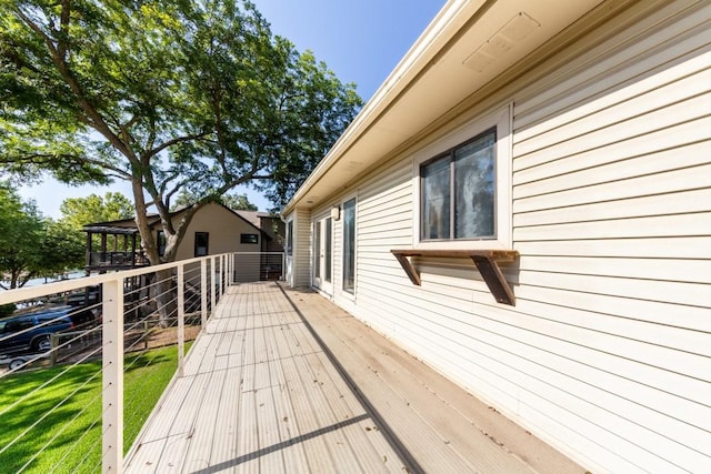 wooden terrace with a yard