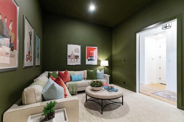 living area with recessed lighting, baseboards, and wood finished floors