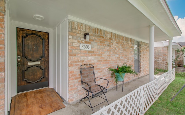 8503 Mcavoy Dr, Houston, TX 77074 - doorway to property with brick siding and a porch