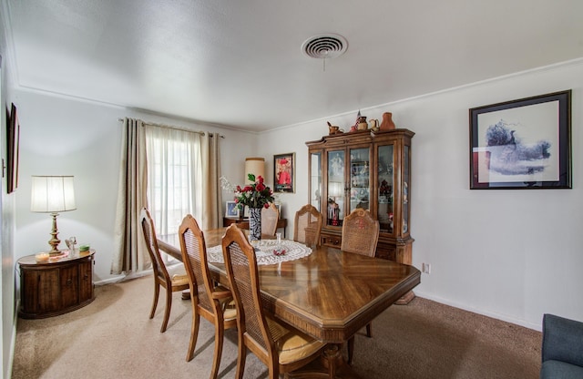 8503 Mcavoy Dr, Houston, TX 77074 - dining space with visible vents, light carpet, and baseboards